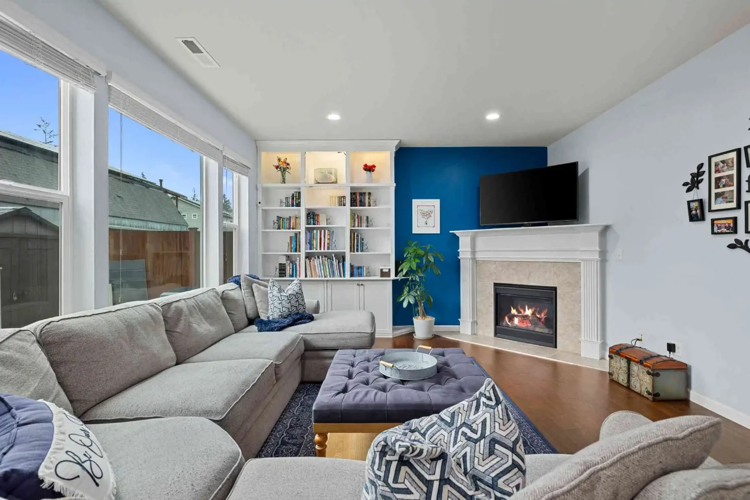 Clean modern living room with sofa seating and TV in bright open interior