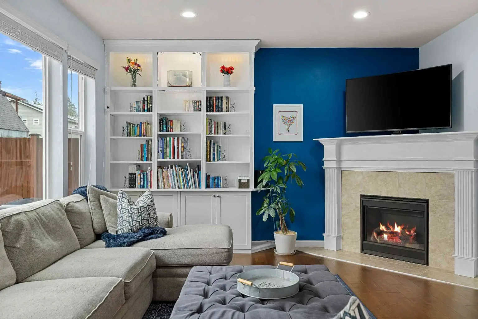 Modern living room with seating, TV, and bright open space